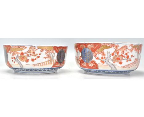 A pair of early 20th Century Chinese ceramic Imari pattern bowls with single blue ring marks to bases. One bowl being larger 