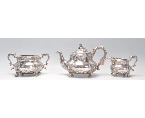 An early Victorian silver hallmarked Robert Hennell III three part tea service having floral and acanthus leaf raised decorat