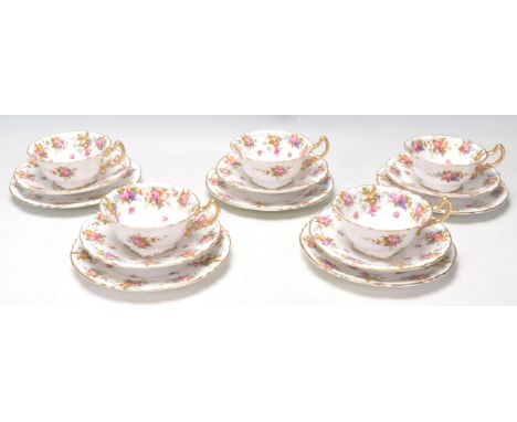 An early 20th Century Edwardian antique Royal Doulton fine bone china tea service decorated with fruits and roses to the rims