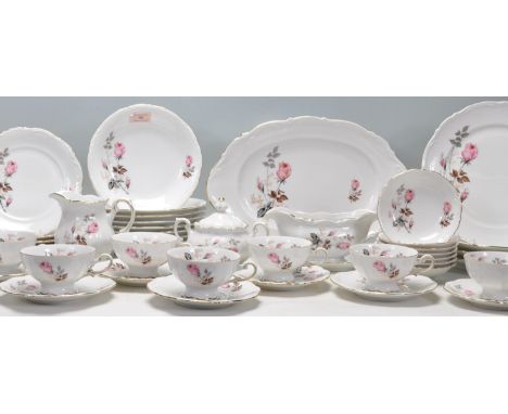 A large vintage German Mitterteich bone china dinner and tea service having moulded rims with printed pink rose decoration an