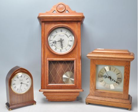 A group of three vintage 20th Century clocks to include an oak cased mantle clock having a silvered dial with Roman numerals 