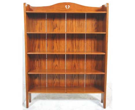 A 19th century Victorian golden oak Arts &amp; Crafts open window bookcase. Raised on arched supports with an upright body of