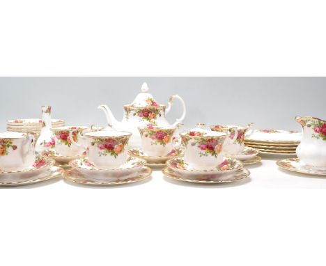 A Royal Albert bone china tea service in the Old Country Roses pattern to include a teapot, dinner plates, bowls, tea cups an
