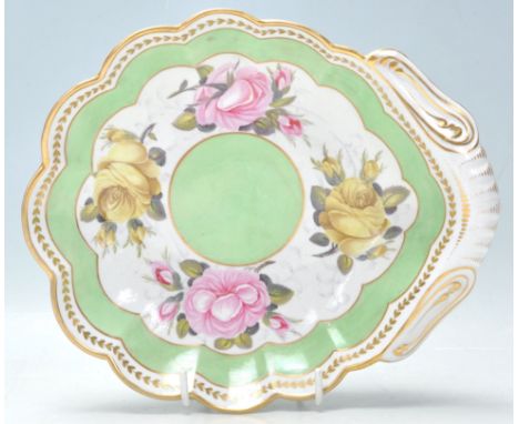 An early 19th Century Georgian Regency period English antique dish of scalloped shape with gilded handle and border with hand