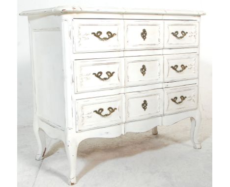 A 19th Century French white painted wood Louis XV style commode - chest of drawers having three panelled drawers with carved 