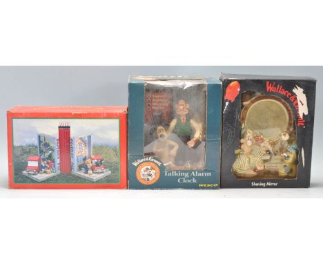 Two vintage Wallace and Gromit collectables to include a talking alarm clock and a novelty Shaving Mirror. Together with two 