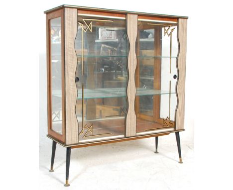 A retro mid 20th Century, circa 1950's formica china display cabinet vitrine. Raised on ebonised legs with shaped roundel fro