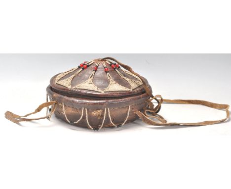 An early 20th Century Vintage tribal Ethiopian injera bread basket. Leather covered with beadwork decoration to the cover and