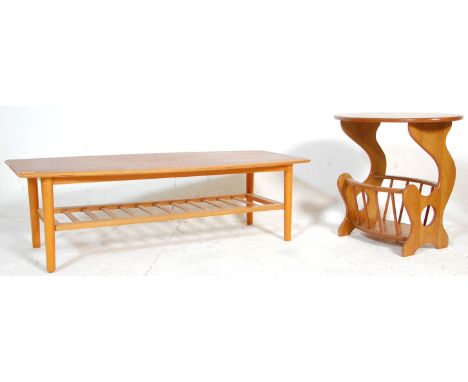 A retro 20th Century Danish inspired surfboard top teak coffee table raised on tapering legs with second tier / magazine rack