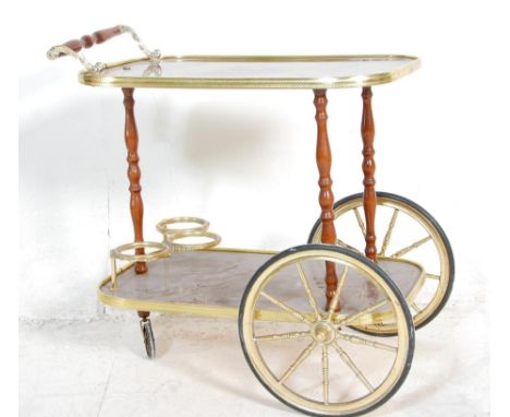 A vintage retro two tier Italian style drinks trolley, brass gallery surround to each tier raised on tuned supports. Oversize