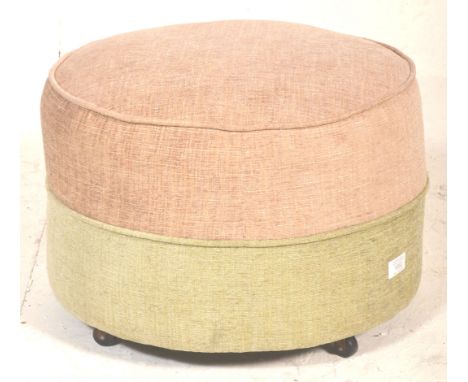 A retro mid century circular barrel foot stool pouffe in a two tone upholstered colourway of beige and pink. Set to block fee