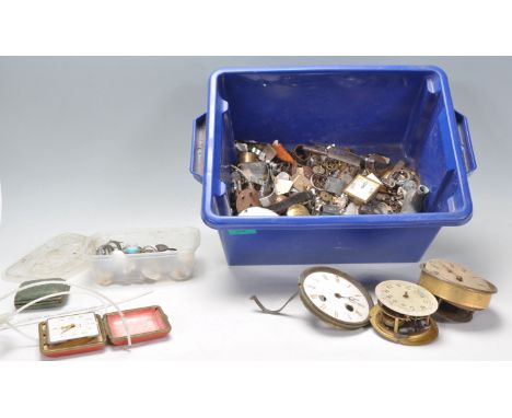 A collection of vintage spare watch and clock parts to include wrist watch faces and movements, enamelled clock faces, cogs b