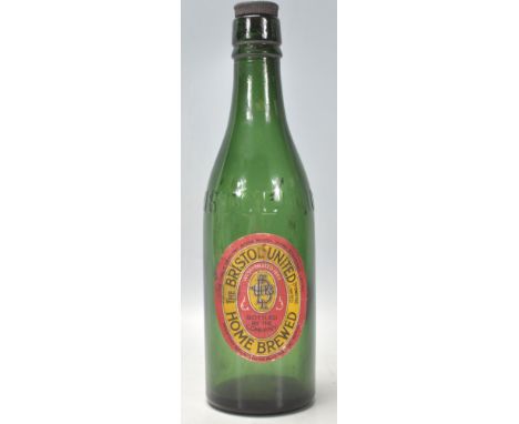A good vintage green glass Bristol United Home Brewed beer bottle having raised Bristol lettering with original label front a