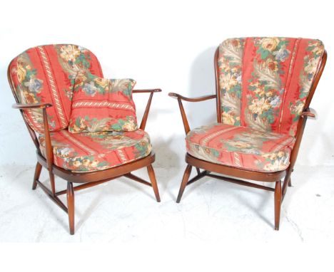 Two vintage retro 20th Century Ercol dark elm stick back open arm lounge chairs one having a round back and the other square,