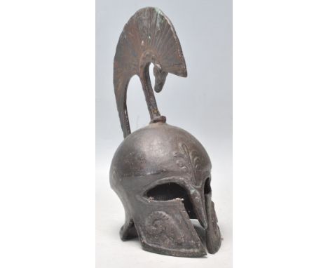 A vintage 20th Century heavy bronze Trojan Helmet having moulded rams head decoration. Measures 21cm tall by 15cm deep.