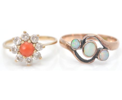 A 9ct gold hallmarked coral and white stone cluster ring. The central cabochon coral with halo of white stones. Total weight 