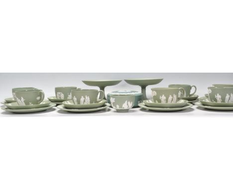 A Wedgwood Green Jasperware tea service compressing of eight tea cups, saucers and side plates and a sugar bowl. Together wit