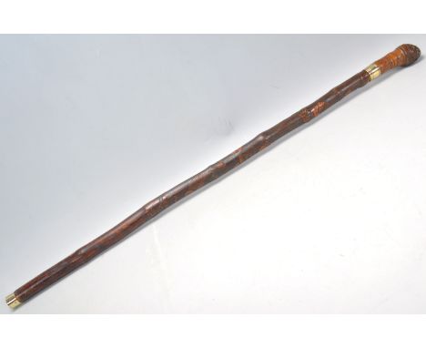 A vintage 20th Century bamboo sword stick / walking stick cane having&nbsp;a root knot ball knob to top. The shaft carved wit