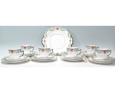 An early 20th Century Art Deco tea service by Balmoral China having white ground with black rim and floral patterns below. Th