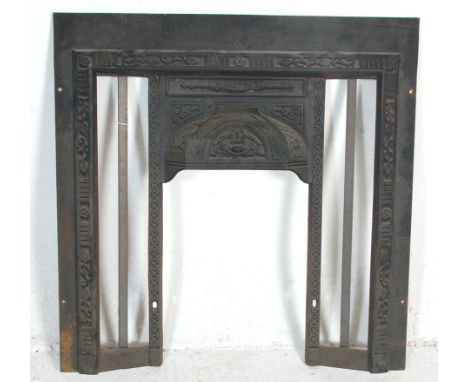 An antique Edwardian Art Nouveau Cast Iron Fireplace surround finely decorated with foliate swirls to its borders and hood. B
