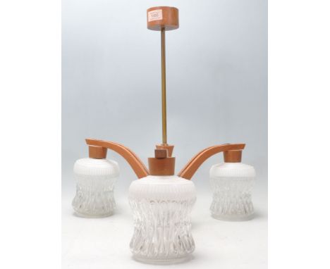 A retro mid century teak wood and glass 3 branch chandelier / electrolier. The chandelier with arched arm and bulbous clear a