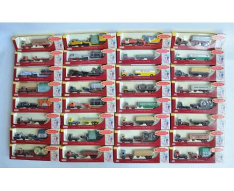 Thirty two boxed Lledo limited edition 1/76 scale (OO gauge) diecast model trucks, all cabs with trailers, some with loads, m