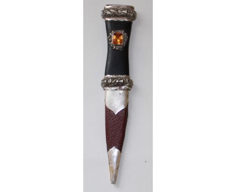 Scottish Sgian Dhu, 3" blade, grip with white metal mounts embossed with thistles, large faceted coloured stones to the grip 