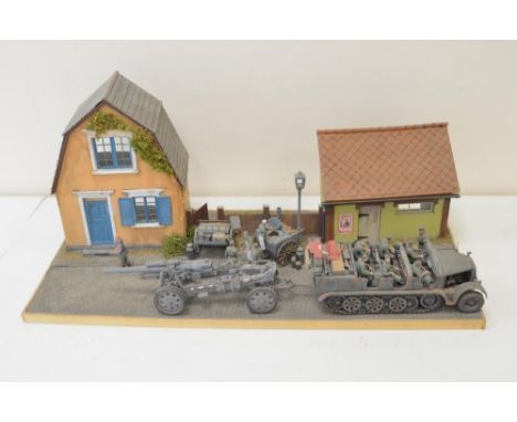 Highly detailed and very well constructed 1/35 scale plastic model WWII diorama depicting German Army Famo and towed artiller