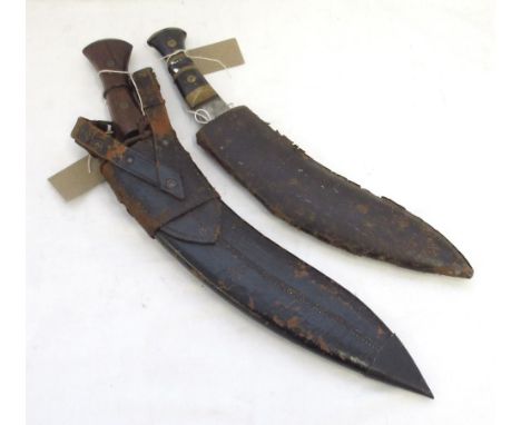 Pair of vintage Kukris, one Indian-made with a leather sheath and wooden hilt, the other unmarked with leather sheath in poor