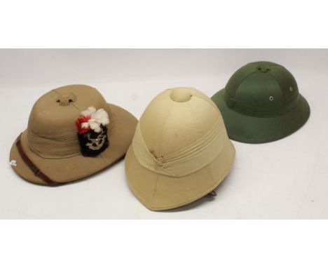 Three vintage pith helmets of varying styles in good condition