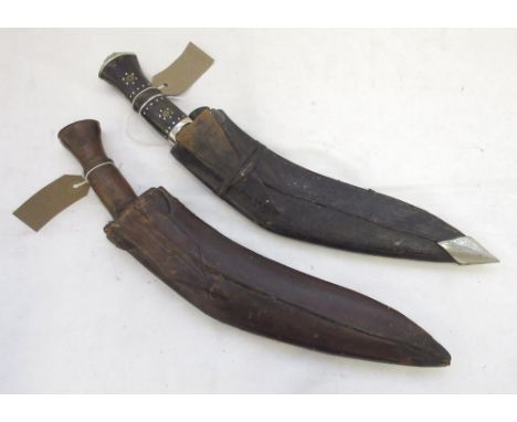 Two vintage Kukris, one with a wooden handle and one with horn, complete with original sheaths. Original Chakmak and Karda wi