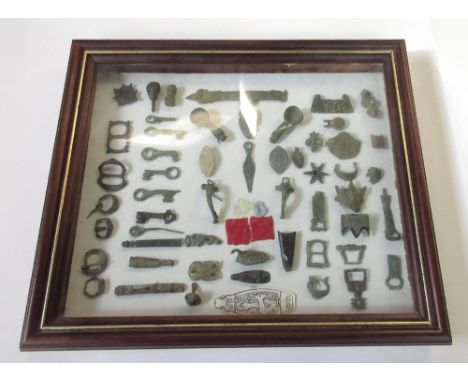 Diverse selection of metal detectorist finds of various styles and periods, mounted in a wooden display case. To include a C9