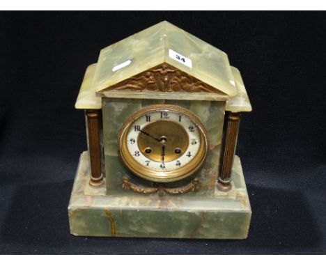 A Green Marble Encased Mantel Clock With Circular Dial