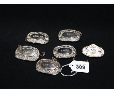 Five White Metal Decanter Labels, Together With A Ceramic Label