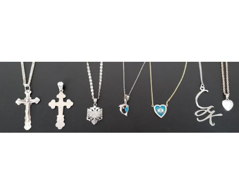 SEVEN SILVER PENDANTSincluding a crucifix, a cross, a double headed eagle, an opal set dolphin and a rhinestone set heart, si