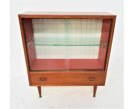 1970s TEAK DISPLAY CABINETwith a pair of glass sliding doors and a glass shelf, with a textured foam back above a frieze draw