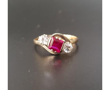 RUBY AND CLEAR GEM SET THREE STONE RINGthe central square cut ruby approximately 0.7cts flanked by round brilliant cut clear 