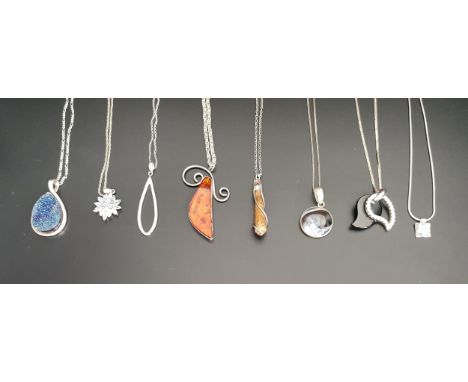 EIGHT SILVER AND SILVER MOUNTED PENDANTSincluding amber and agate set examples and an opal set pendant, all on silver chains 