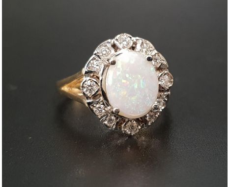 OPAL AND DIAMOND CLUSTER RINGthe central oval cabochon opal measuring approximately 9.7mm x 7.5mm, in twelve diamond surround