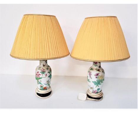 PAIR OF HEREND PORCELAIN TABLE LAMPSdecorated with flowers and butterflies, both with pleated yellow shades, 51cm high includ