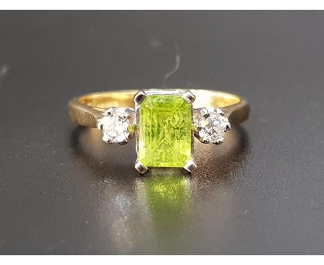 PERIDOT AND DIAMOND THREE STONE RINGthe central emerald cut peridot approximately 1ct flanked by round cut diamonds totaling 