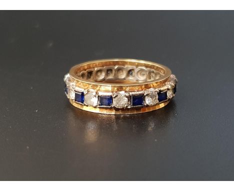 BLUE SAPPHIRE AND CLEAR GEM SET ETERNITY RINGin nine carat gold, ring size O and approximately 4 grams 