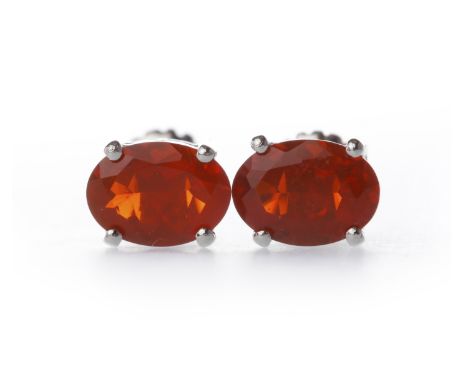 PAIR OF PLATINUM FIRE OPAL EARRINGSthe oval stones each measuring approximately 6.9x5mm, with screwback fittings, 2.6g