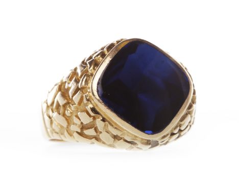 BLUE GEM SET DRESS RINGthe collet set blue gem of approximately 13mm, on decorated shoulders, size R, 8.4g