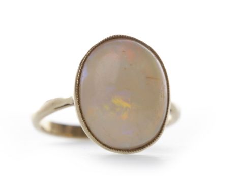 EDWARDIAN OPAL RINGset with a large cabochon cut white opal 15mm long, in a millegrain edged collet setting, in nine carat go