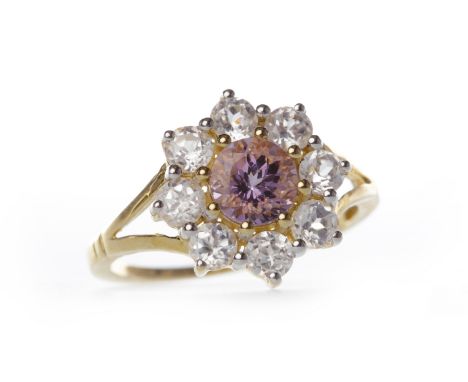 NINE CARAT GOLD GEM SET FLOWER CLUSTER RINGthe central purple stone surrounded by round white gems, size J-K, 1.9g