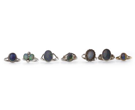 GROUP OF SILVER OPAL AND OPAL SIMULANT DRESS RINGSincluding one in nine carat gold (7)