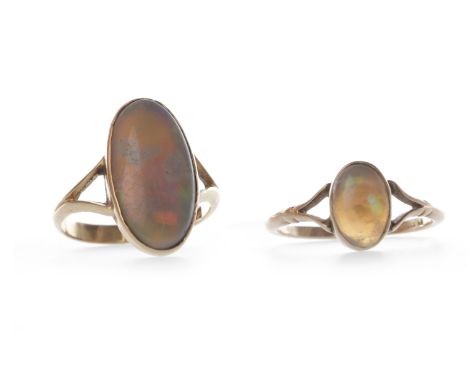 TWO EARLY TWENTIETH CENTURY HARLEQUIN OPAL RINGSeach set with an oval section of opal on bifurcated shoulders, the smaller si