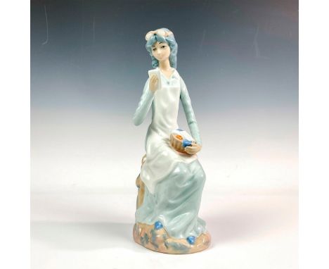 Glossy finish modeled as a lady seated on a tree trunk opening letters. Casades backstamp. Dimensions: 3.5"L x 5"W x 11.5"HMa