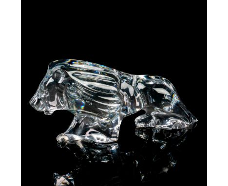 A large, clear figure of a male lion stalking. Baccarat marked. This item has its original box: 11.75"L x 5"W x 5"H. Dimensio